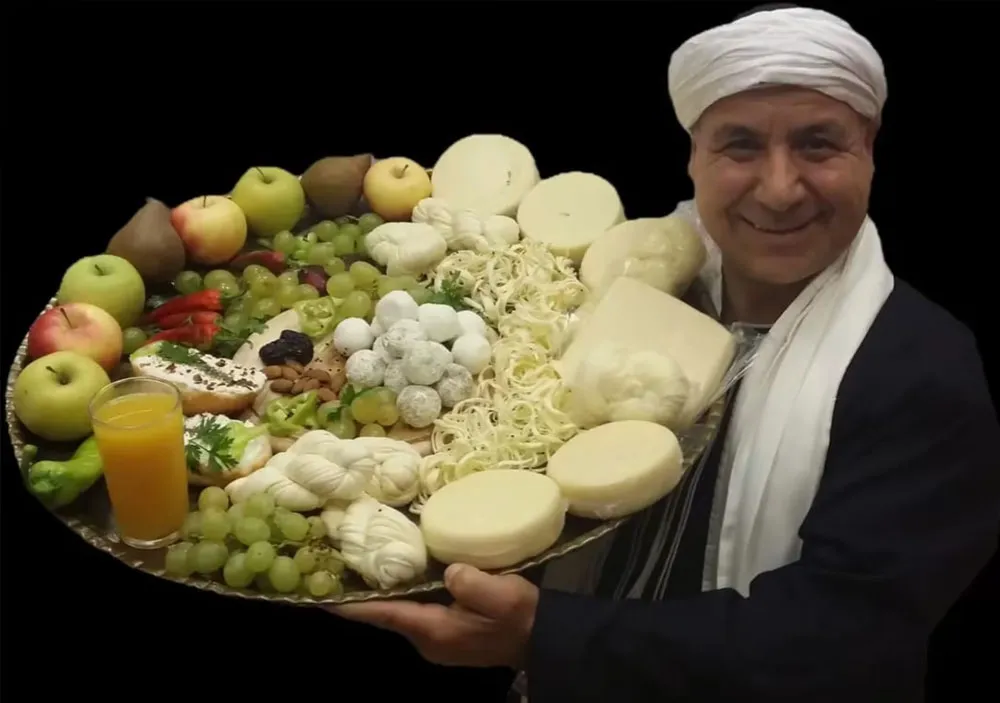 Sultan Cheese cheesemaker presenting a platter of cheeses